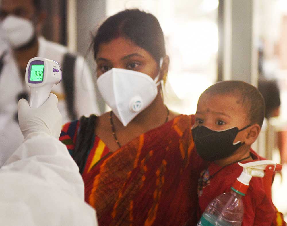 Health workers conduct thermal screening of passengers who have arrived from Delhi by a special train at Howrah station, during the ongoing Covid-19 nationwide lockdown, in Calcutta, Friday, May 15, 2020.