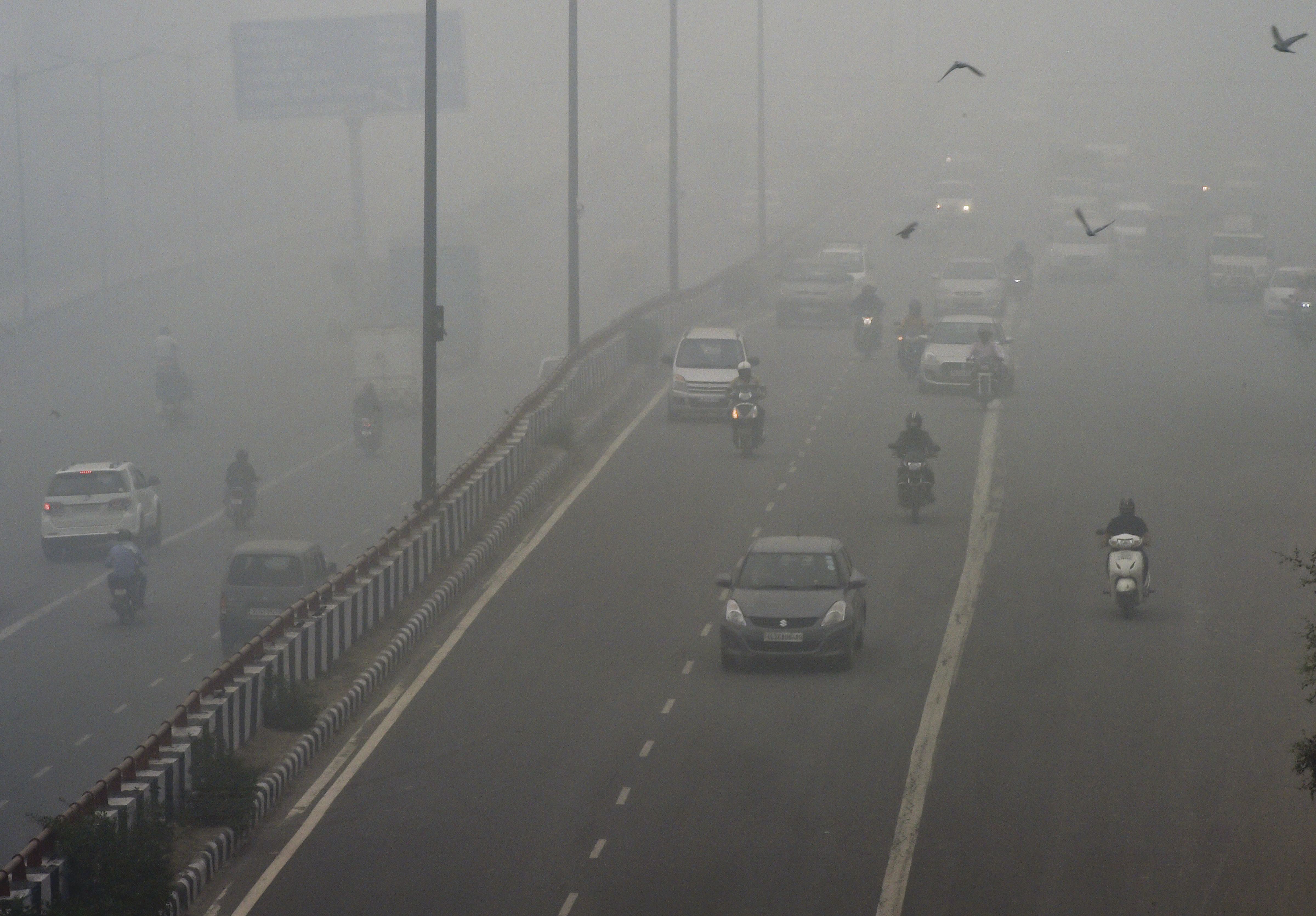 Vehicles ply on a road amid heavy smog, in New Delhi, Sunday, Novembe 3, 2019.