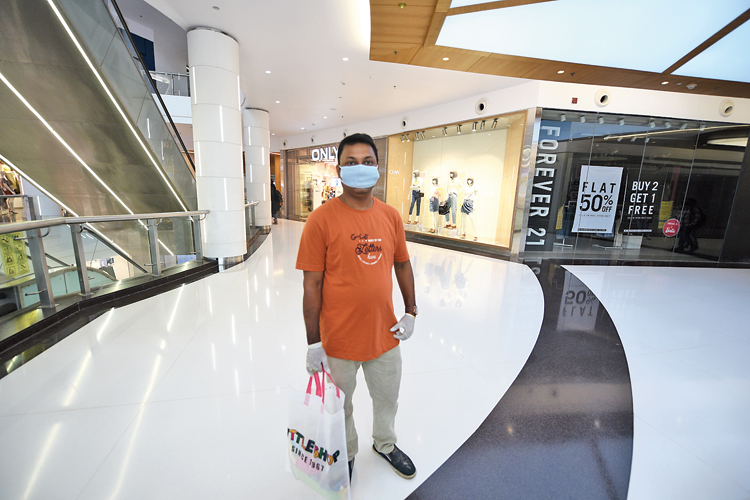 Doting dad: Among the early birds at South City mall was a father who was looking for a dress for his daughter’s eighth birthday. “How long will we live in fear?” asked IT professional Sankhadip Sikdar, a shopping bag in hand. “I last shopped for her around Christmas,” the father said. 
The child had wanted to join her father in the shopping expedition but was not allowed by her parents because of her age.  Sankhadip said he was carrying a hand sanitiser and using it frequently.  “And I am keeping a safe distance from others.”