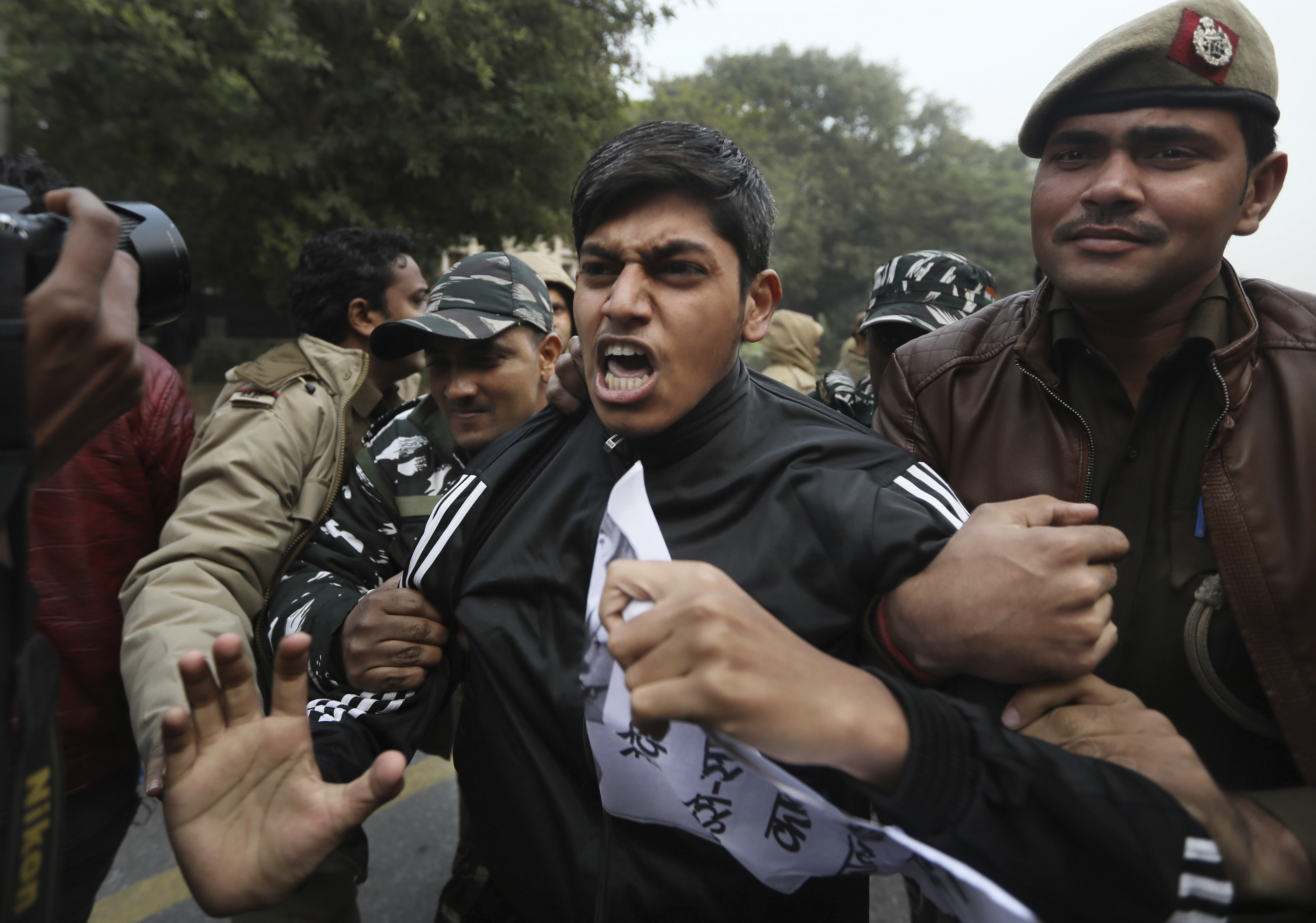 Policemen detain students protesting outside Uttar Pradesh Bhawan during a protest against the citizenship law and violence by police in the state, in New Delhi, India, on December 27, 2019