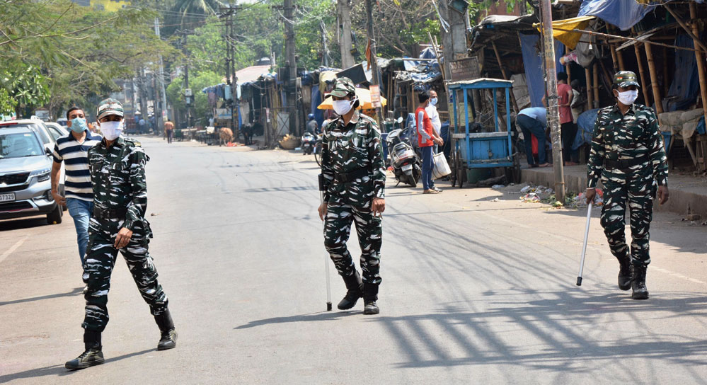 Women security personnel, sporting masks, patrol a street in Guwahati on Friday amid the lockdown. 
