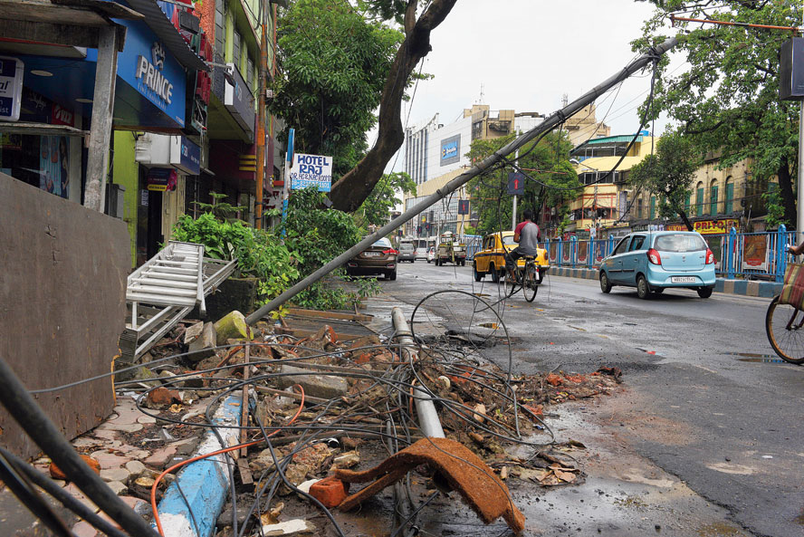 Debris, a broken lamp post and torn wires on Rashbehari Avenue on Saturday.