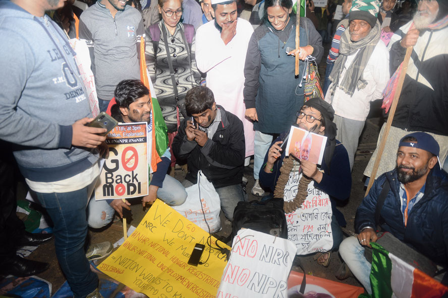 A group of protesters staging a skit on JL Nehru Road on Saturday evening. “I am the first Prime Minister to have lied from the Red Fort….,” said one of them, his face hidden by a Modi mask