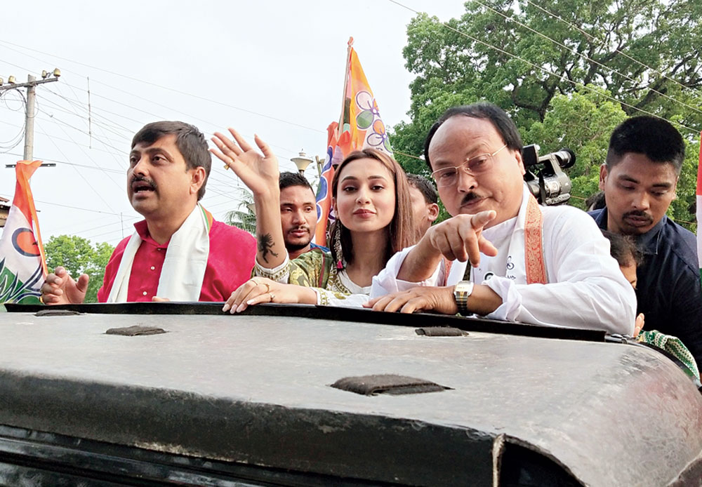 Mimi holds the road show for Trinamul candidate Bijoy Chandra Burman (right) in Jalpaiguri. 
