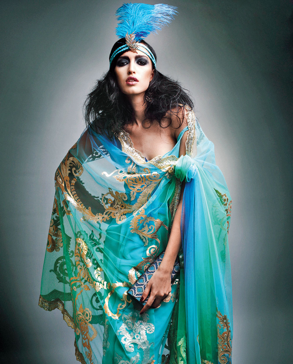 Tamara Moss in Suneet Varma’s Swan Lake collection — applique tulle sari with feathered headgear complemented by Suneet Varma for Judith Leiber Jali Bag in 2017
