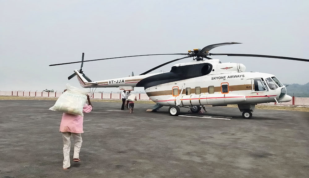 A worker transfers sacks of grains from a vehicle to a chopper for distribution at Miao in Changlang district on Thursday. 