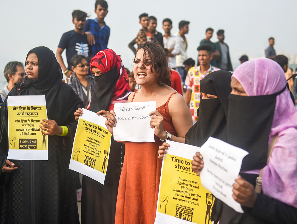 Activists raise slogans demanding for Centre to create a strong system of deterrence punishment to rapists in the country against sexual violence, in Mumbai, Sunday, December 8, 2019.