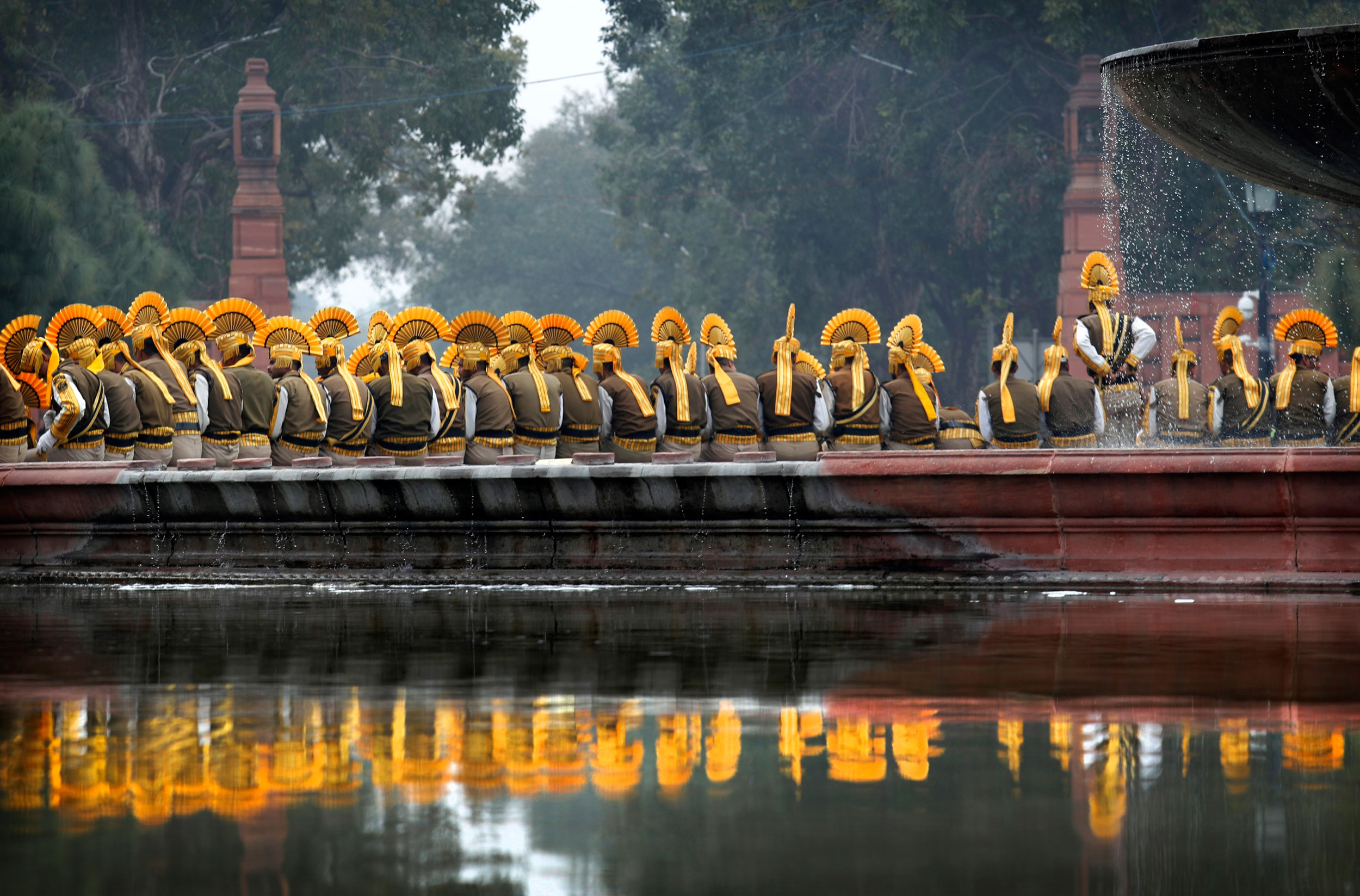 Indian paramilitary soldiers take a break during the rehearsals for the Republic Day parade at the Raisina hills in New Delhi on Monday