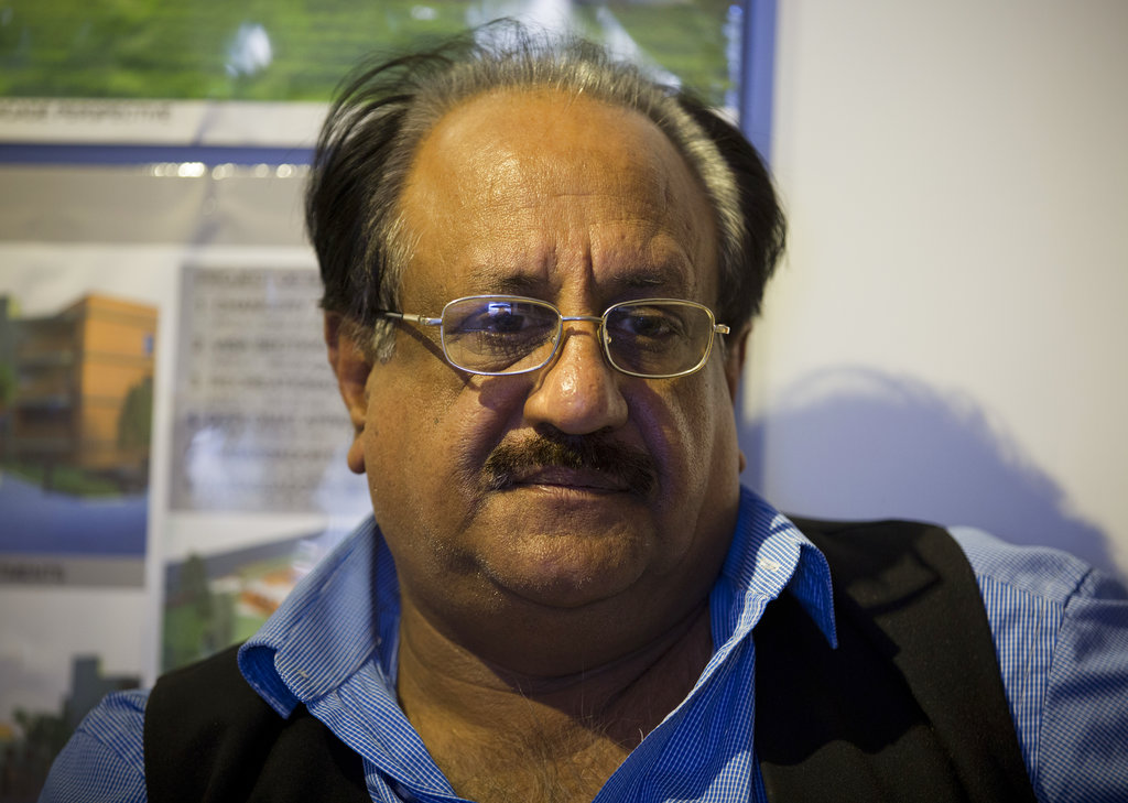 Chaudry Javed Atta speaks to The Associated Press in Islamabad. The last time Atta saw his wife was over a year ago.
