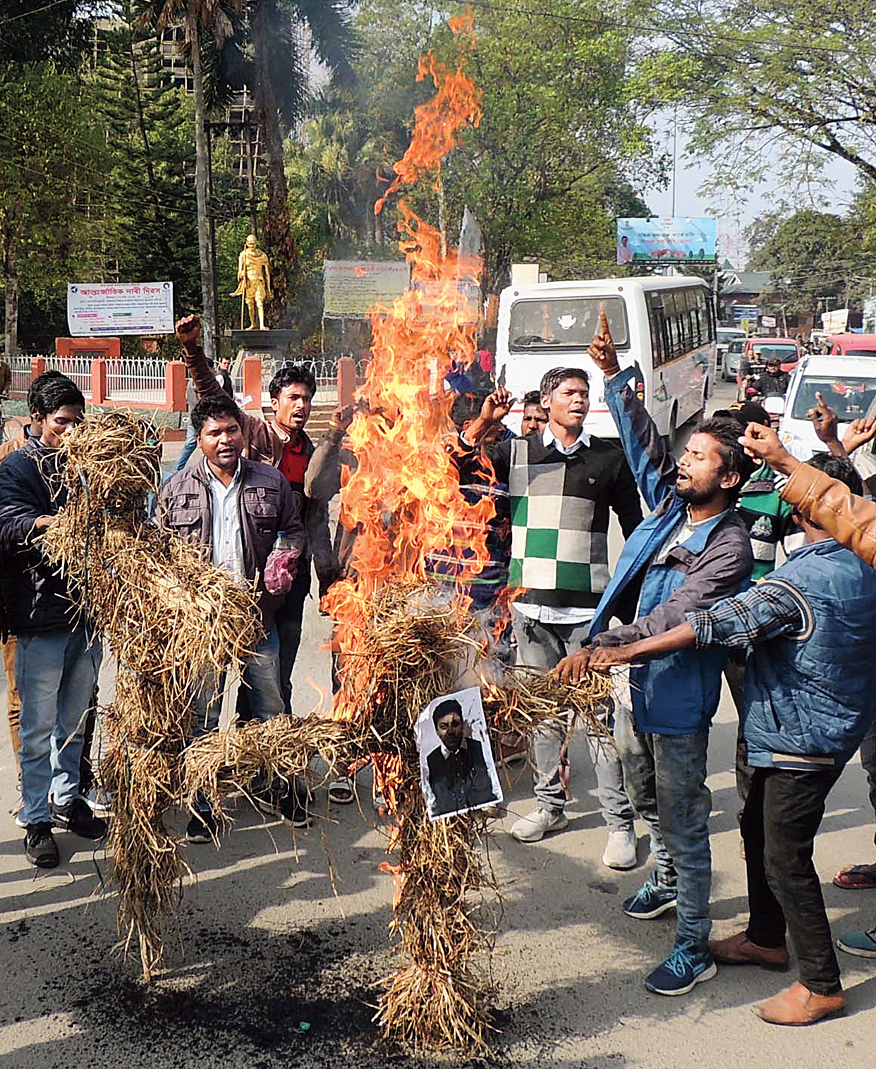 Members of the All Assam Adivasi Students’ Union  burn effigies of excise minister Parimal Suklabaidya and tea tribes welfare (independent charge) minister Pallab Lochan Das in Golaghat on Monday to protest against the hooch incident. 