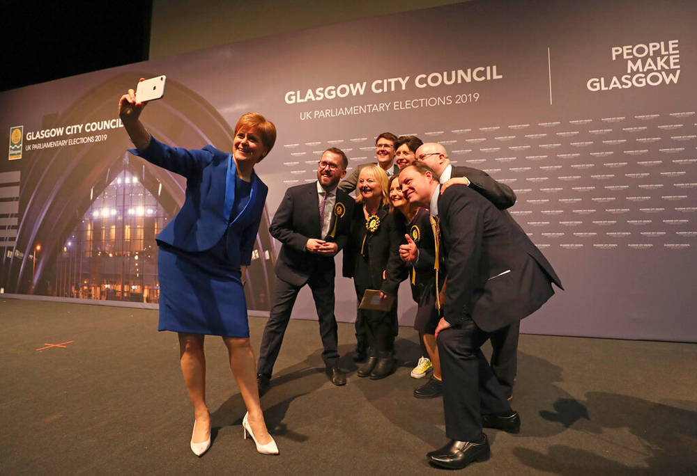 Scottish First Minister Nicola Sturgeon takes a photo with party members in Glasgow on December 13