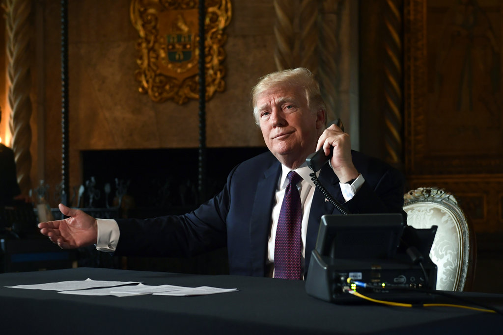 Trump asks if reporters can hear the audio as he talks to troops via teleconference from his Mar-a-Lago estate in Palm Beach, Florida, on Thursday.