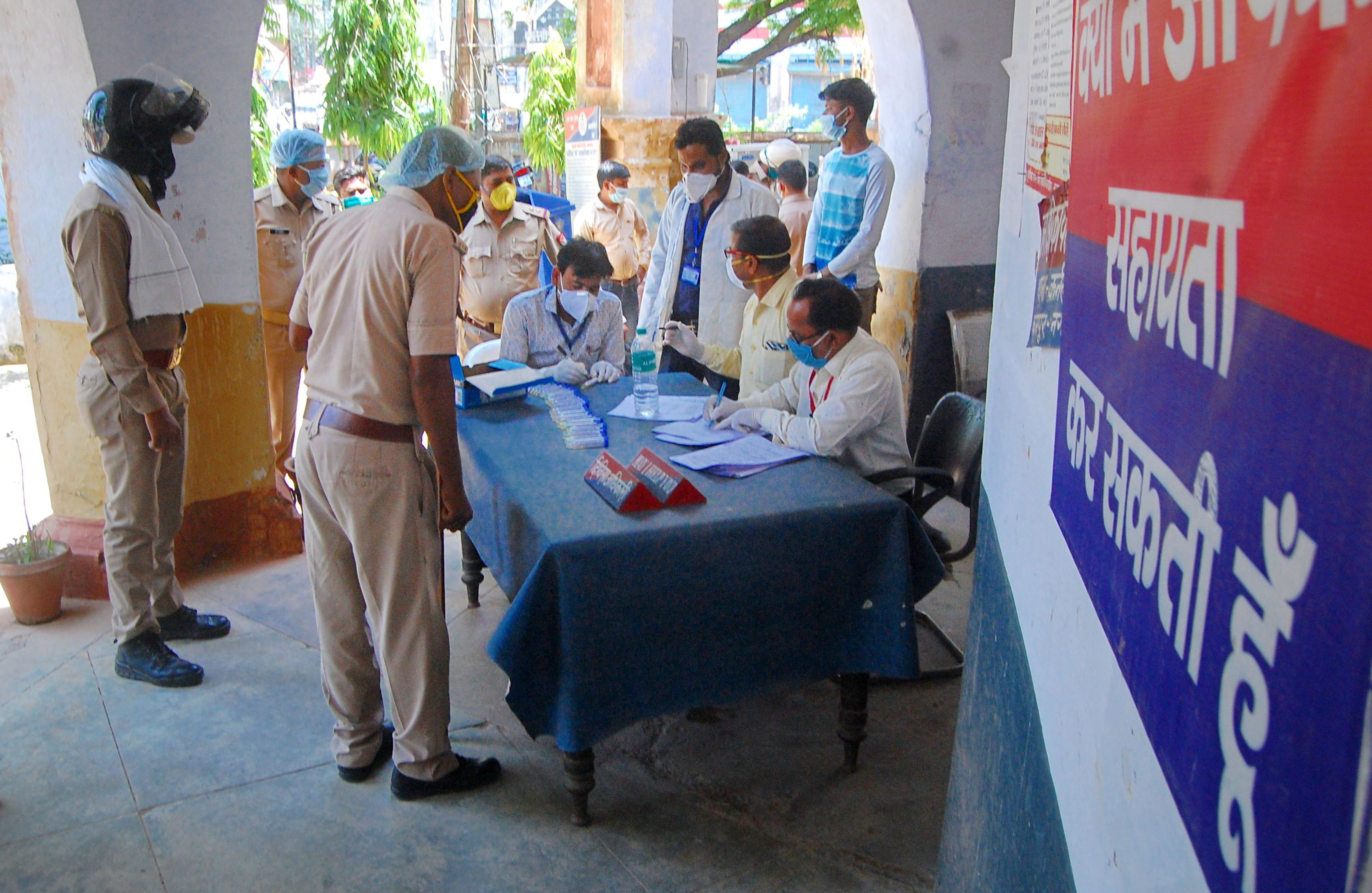Medics examines police personnel in the wake of coronavirus pandemic at Karnalganj police station, during the nationwide lockdown, in Gonda district, Thursday, May 07, 2020