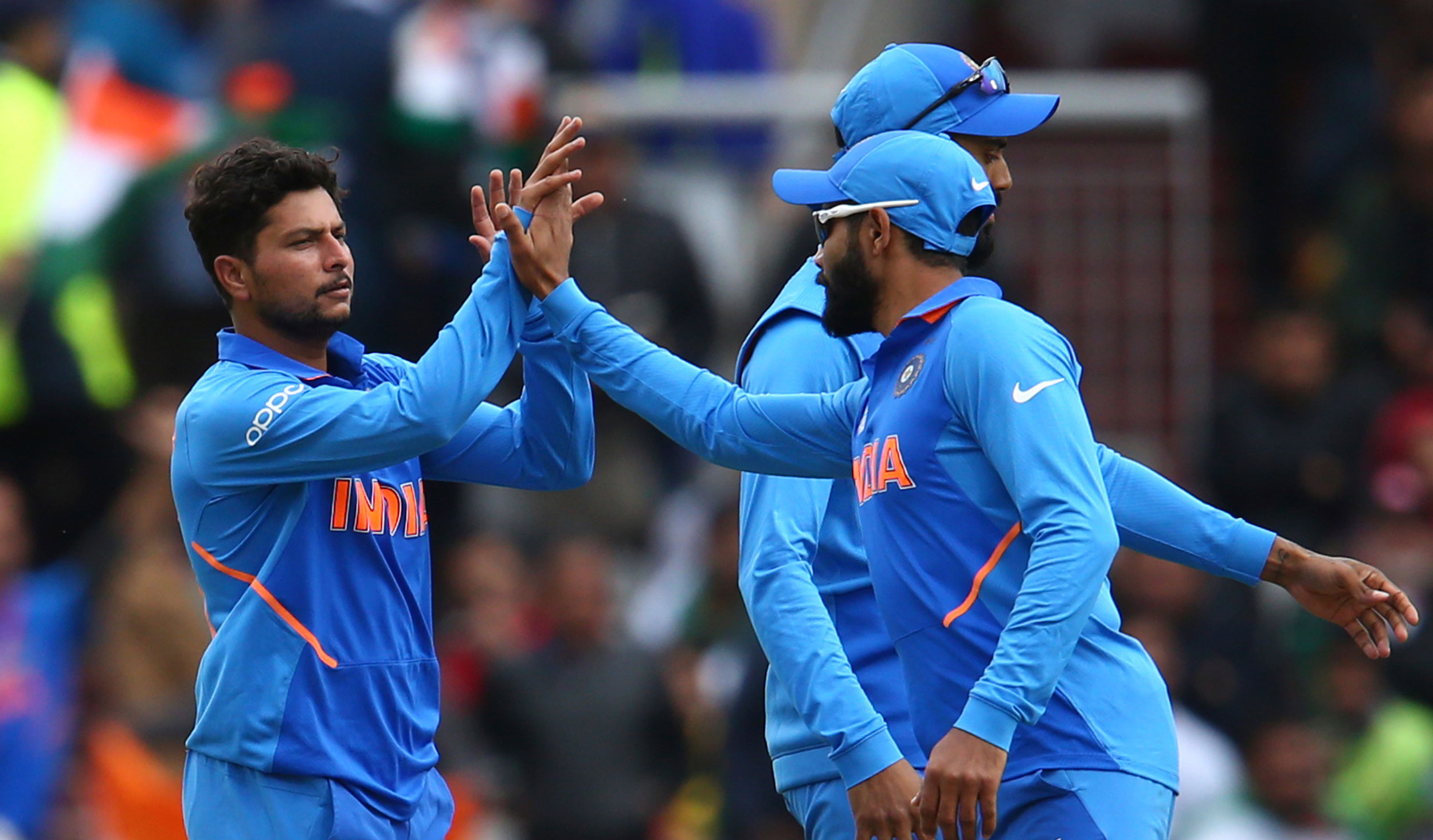 Kuldeep Yadav (left) celebrates after taking the wicket of Pakistan's Babar Azam during the ICC Cricket World Cup match between India and Pakistan at Old Trafford in Manchester, England, on June 16, 2019. 