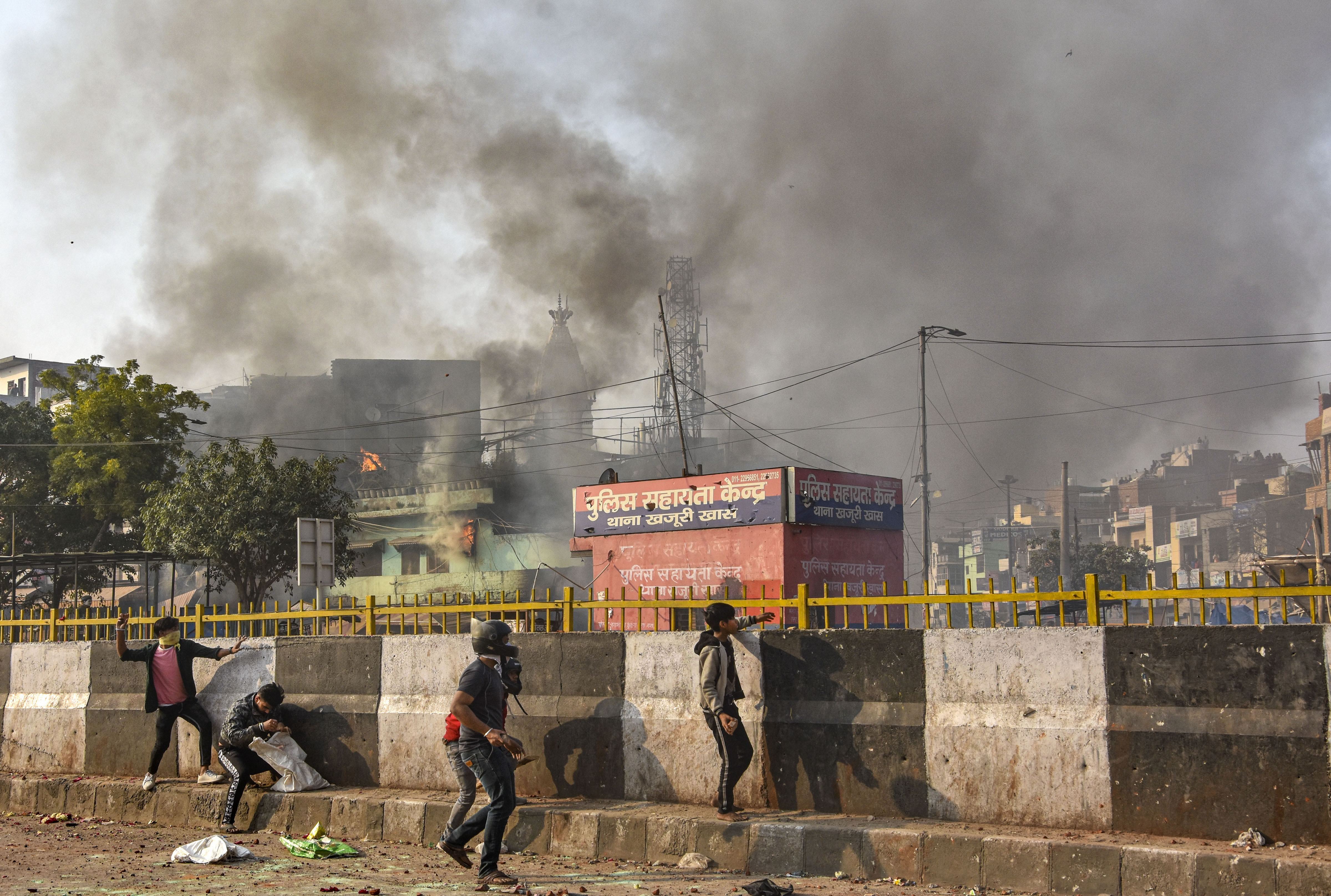 Protesters throw brick-bats during clashes between anti and pro CAA groups, at Chand Bagh in Bhajanpura, in north-east Delhi, Monday, February 24, 2020