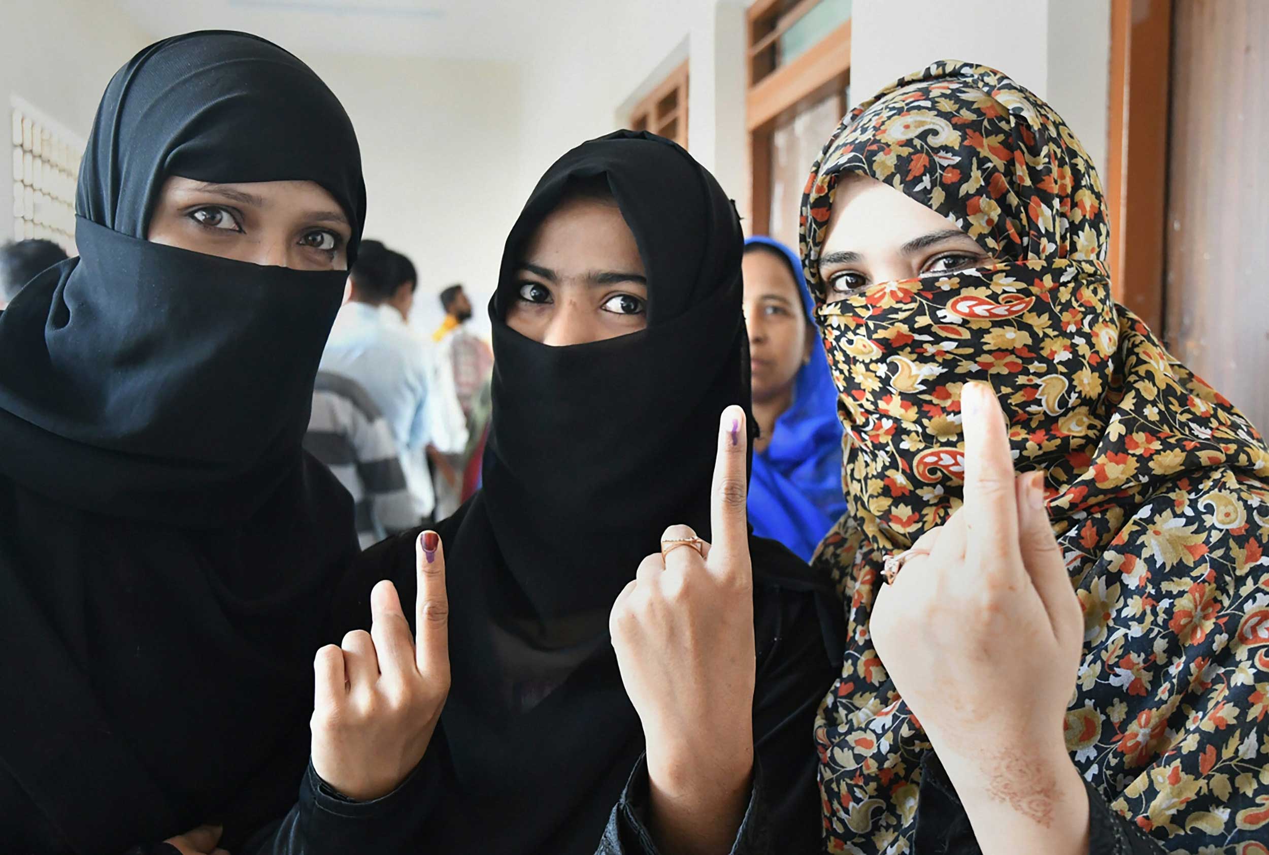 Women show their fingers marked with indelible ink after casting votes for the Assembly elections, outside a polling station in Bhopal on Wednesday. 