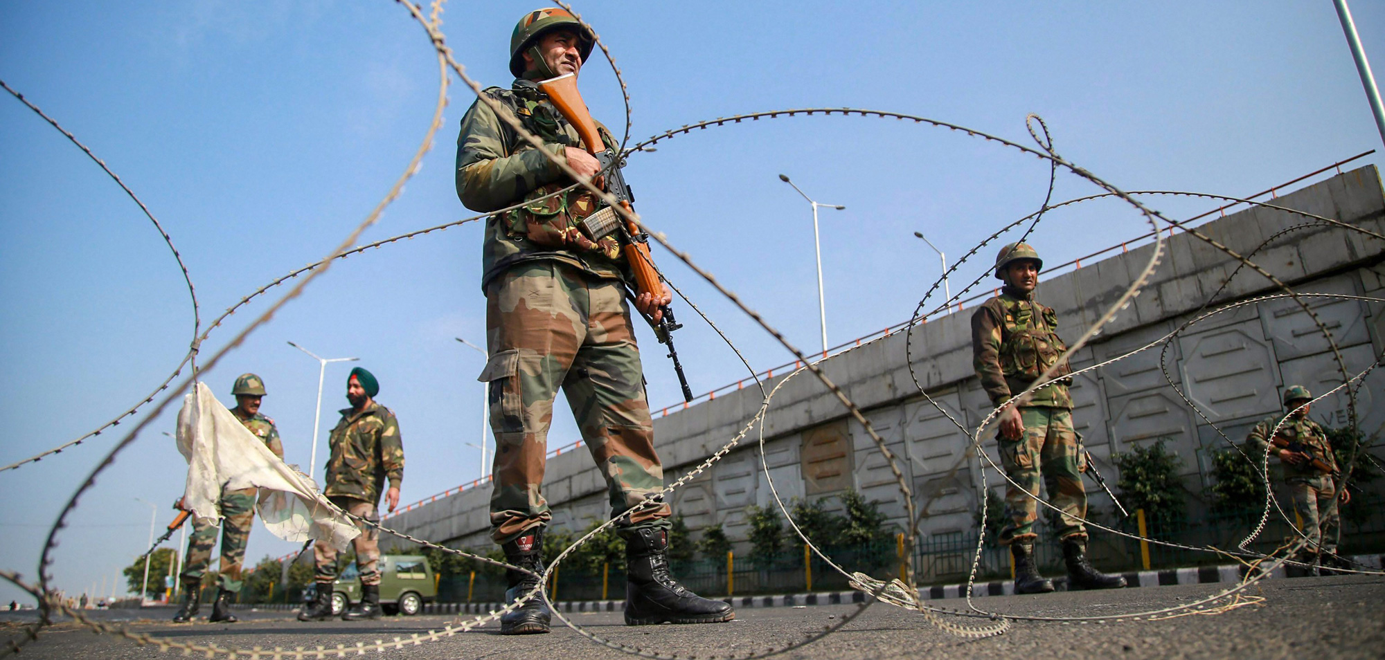 Army personnel stand guard at Bikram Chowk during a curfew, imposed after clashes between two communities over the protest against the Pulwama terror attack, in Jammu on Saturday, February 16, 2019.