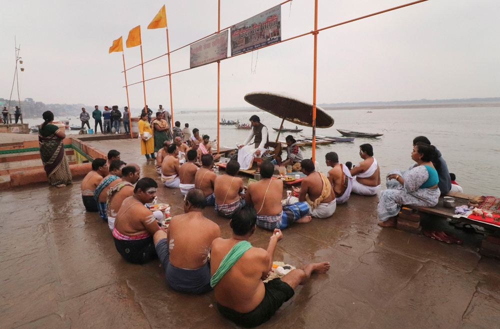 Devotees perform rituals on the bank of the Ganga in Varanasi on December 14