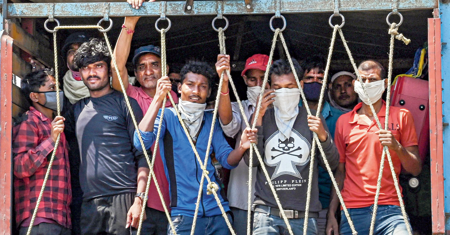 Migrants travel in a truck in Jabalpur, Madhya Pradesh, on Monday.