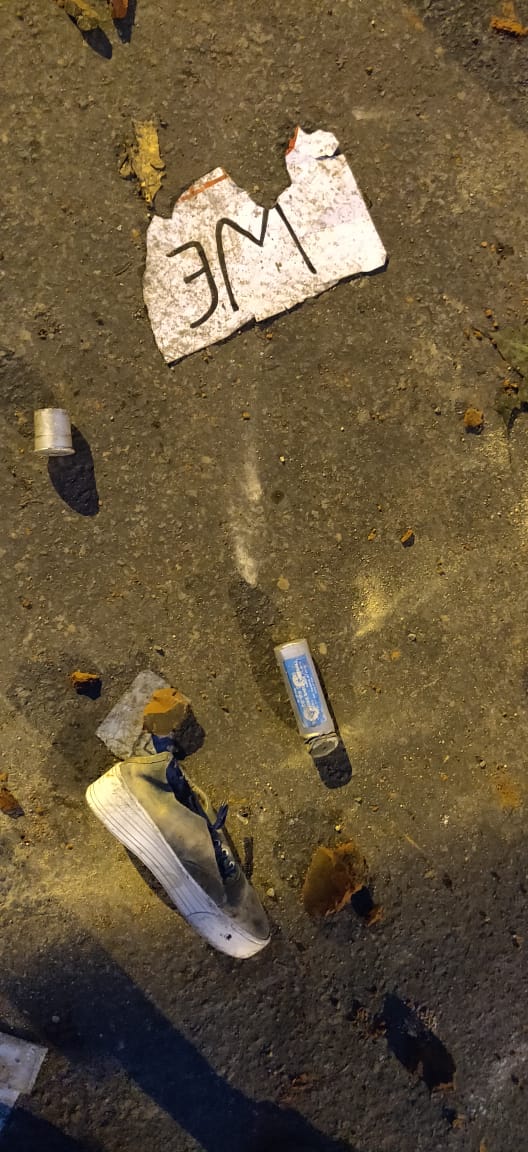 A tear gas shell is seen on the ground between a torn placard and a lost shoe, during a protest by Jamia Millia Islamia University students against the Citizenship Act , in New Delhi, Friday, December 13, 2109.