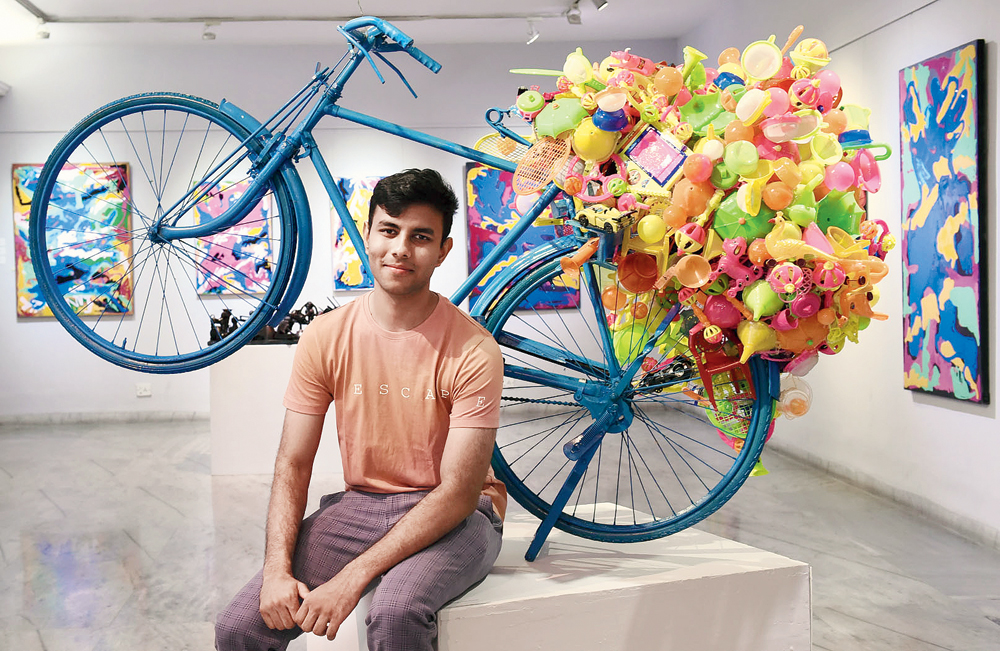 Aahel Iyer with his artwork, Plastic Peddler, that captures his childhood image of a toy dealer cycling his wares to various stores