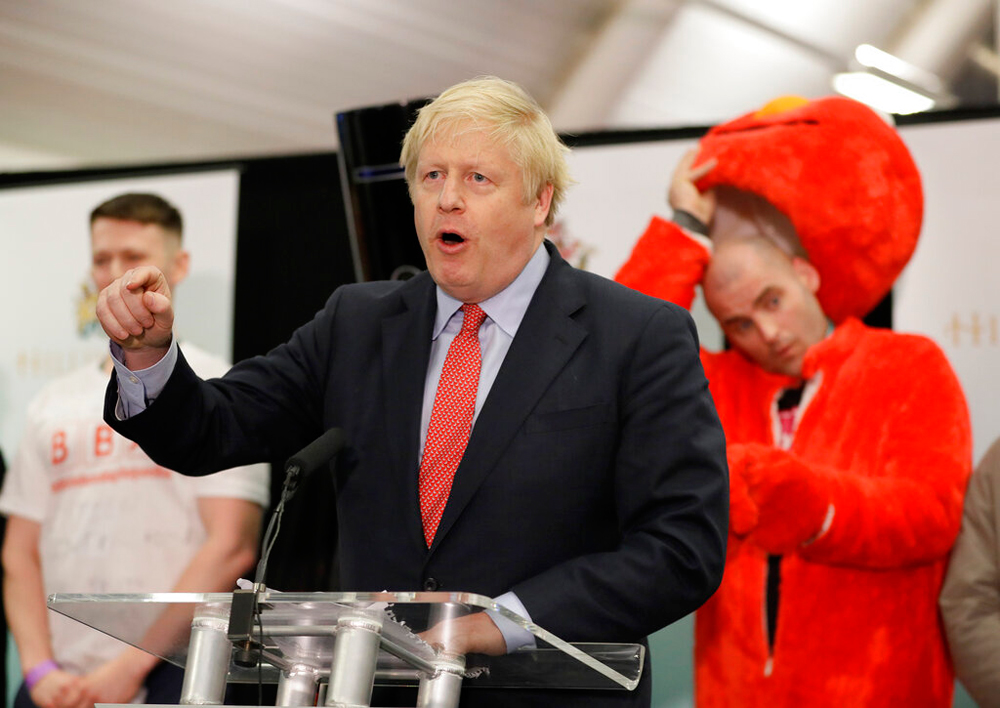 Boris Johnson in London on December 13. Also seen in the photo is Bobby Smith, a political and fathers' rights activist and founder and leader of the 'Give Me Back Elmo' party