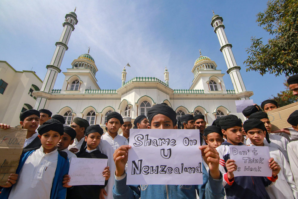 Children hold placards to condemn the New Zealand mosque attack in Jammu on Saturday
