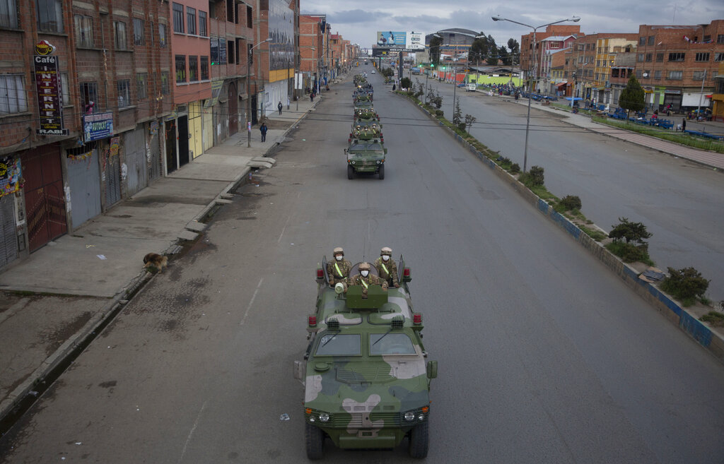 Military armored vehicles patrol the streets during a quarantine in El Alto, Bolivia, Friday, March 20, 2020. Authorities have decreed a quarantine from 5pm to 5am in an attempt to stop the spread of the new coronavirus.