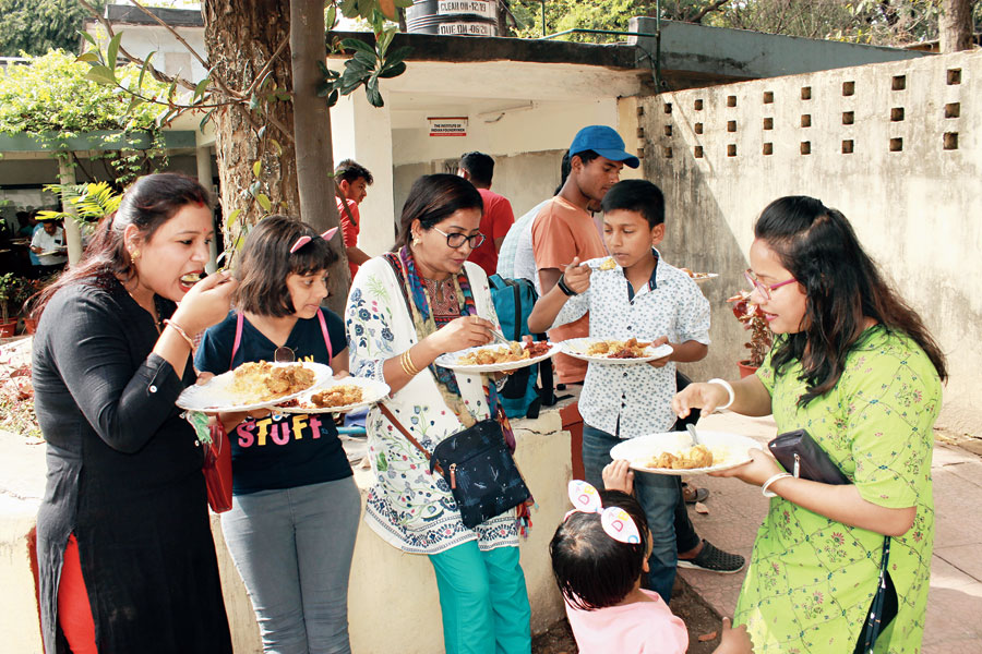 Visitors enjoy the food at the chicken festival in Telco.