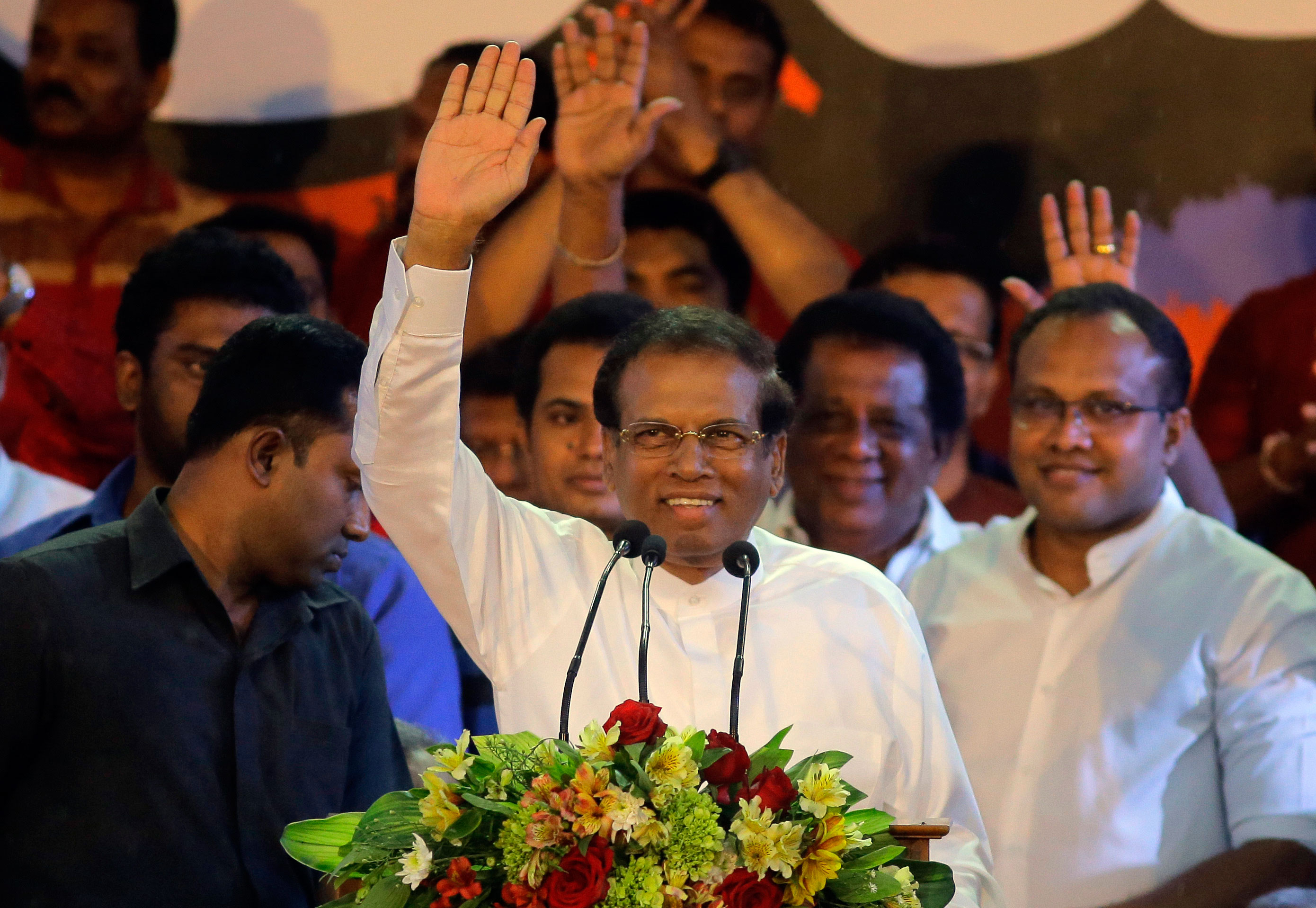 Sri Lankan President Maithripala Sirisena waves to supporters during a rally outside the parliamentary complex in Colombo on November 5, 2018.