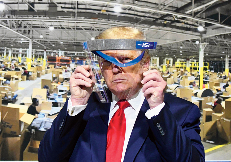 President Donald Trump looks through a face shield while touring a Ford plant in Ypsilanti, Michigan. 
