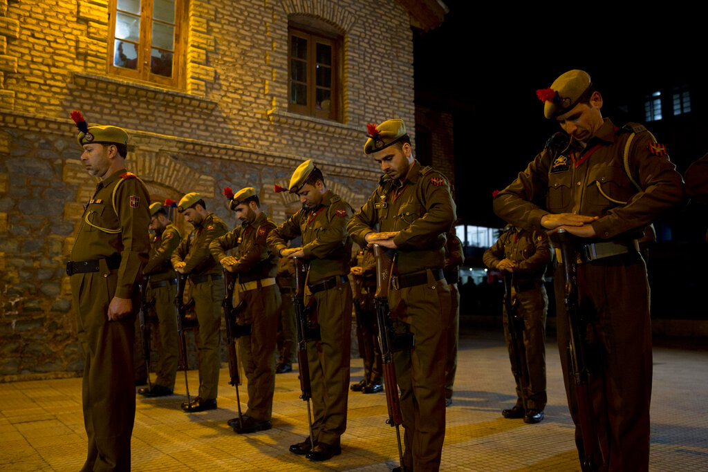 Policemen pay homage during a wreath-laying ceremony of their colleague in Srinagar on Monday.