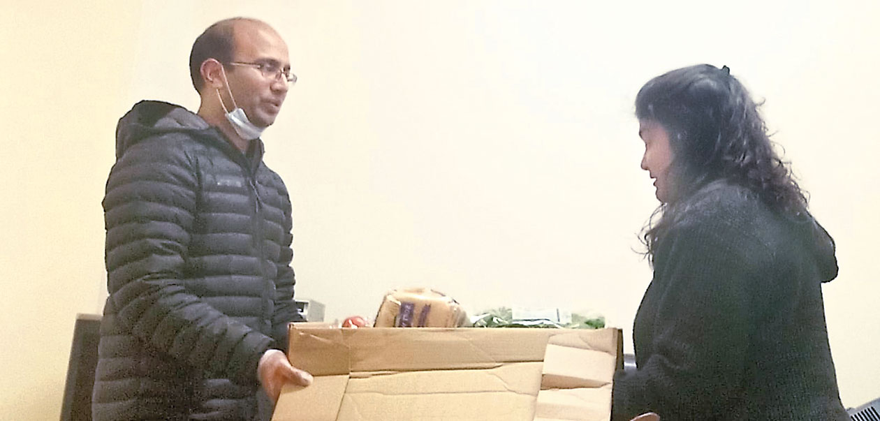 Student Barsha Bhattacharya receives a gift of groceries