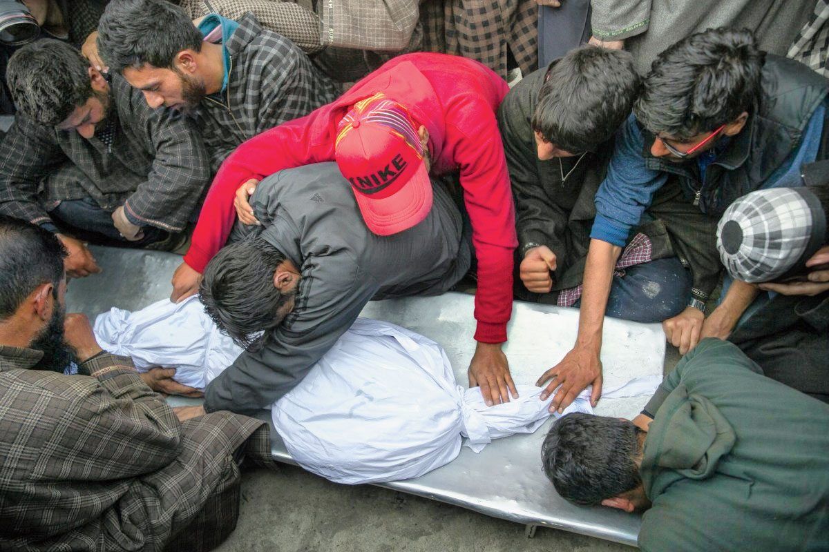 Villagers grieve near the body of an 11-year-old boy, Aatif Mir, in north of Srinagar, on March 22, 2019.