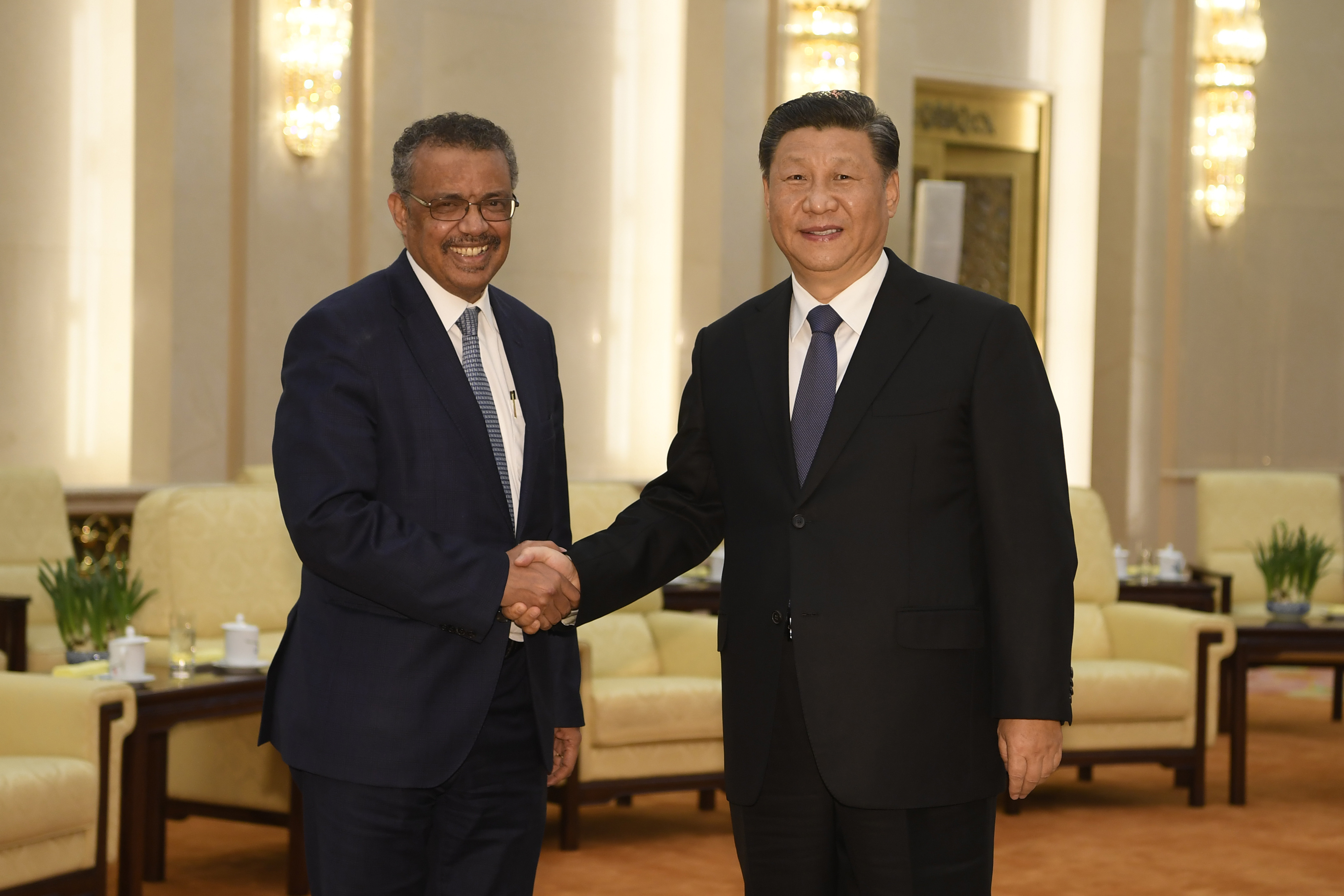 Tedros Adhanom, director general of the World Health Organization, left, shakes hands with Xi Jinping before a meeting at the Great Hall of the People in Beijing, on January 28, 2020