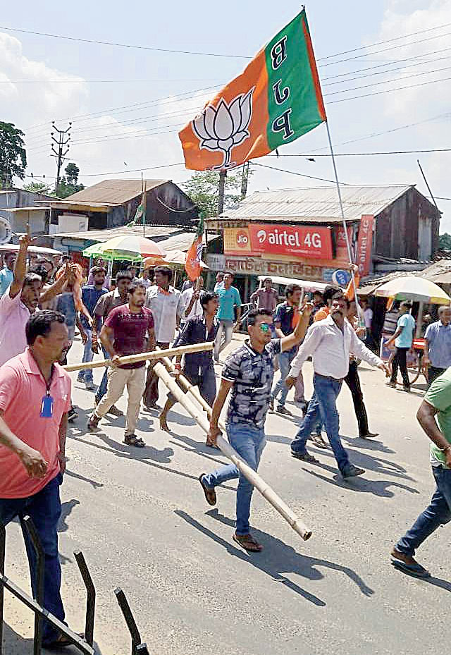 BJP supporters wielding party flags and sticks in Gangarampur.