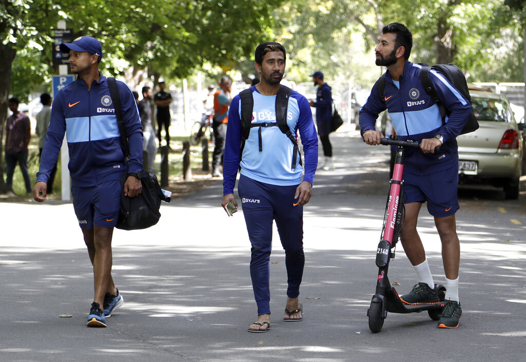Cheteshwar Pujara, right, rides an electric scooter as he leaves Hagley Oval with teammates, Mayank Agarwal, left, and Wriddhiman Saha, centre, following a practice session ahead of the second cricket test against New Zealand in Christchurch, New Zealand