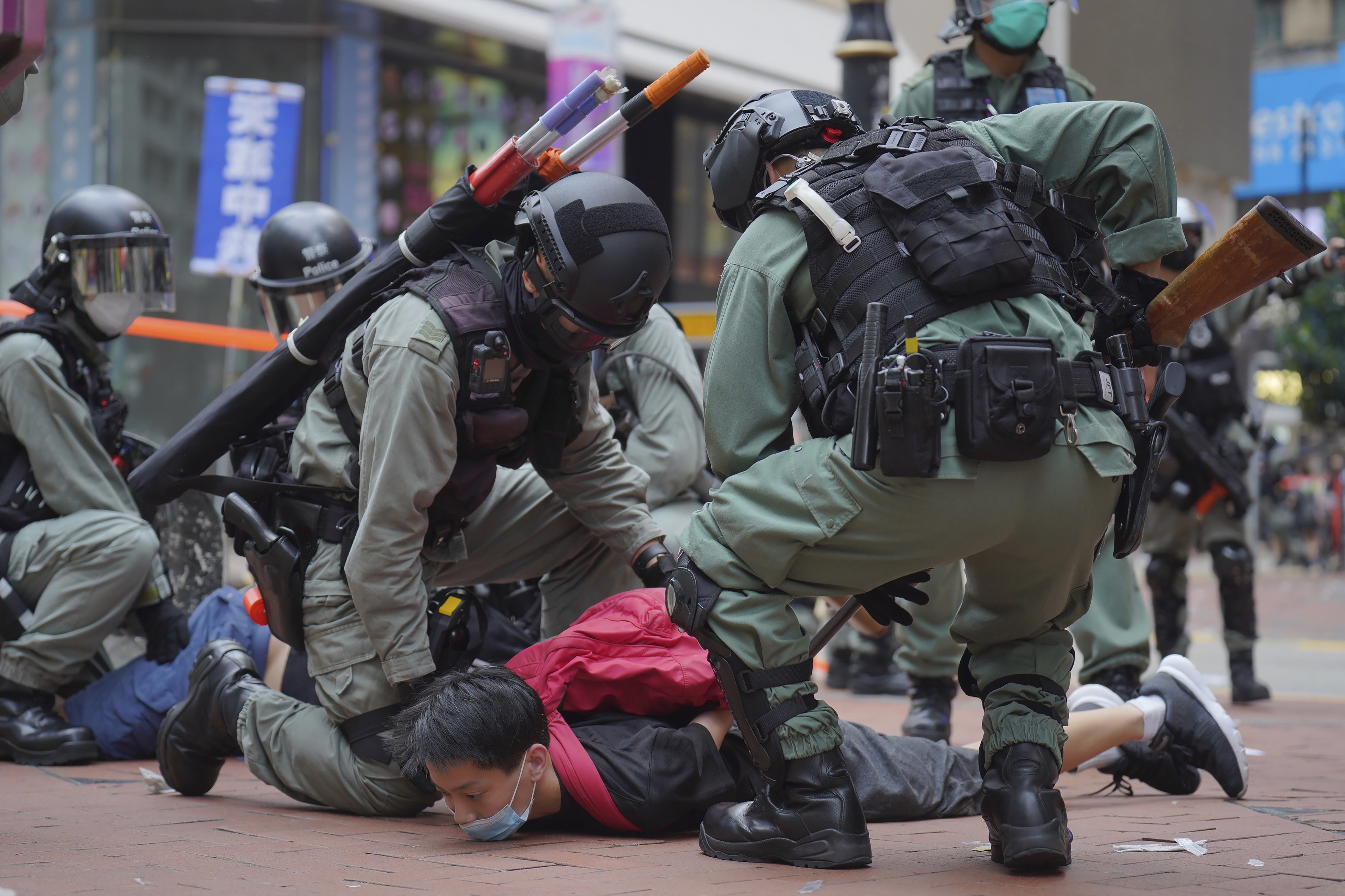 Riot police detain a protester during an anti-China demonstration in Hong Kong