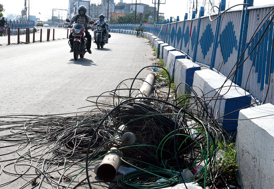 Snapped cables and wires lie on Bijon Setu on Wednesday
