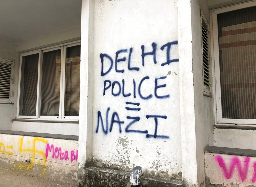 Graffiti on a a building wall at Jamia Millia Islamia University in New Delhi. “The anti-national Modi govt decides to commercially export hydroxychloroquine under Trump’s pressure! Meanwhile, it arrests activists branding them ‘anti nationals’!... Increase the testing rate, not communal hate!