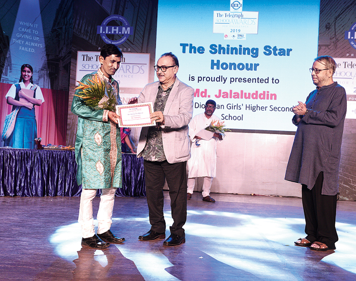 Md Jalaluddin receives the award from Bhupati Das, a management professor from Guwahati and chairman of the jury for The Telegraph School Awards for Excellence Northeast