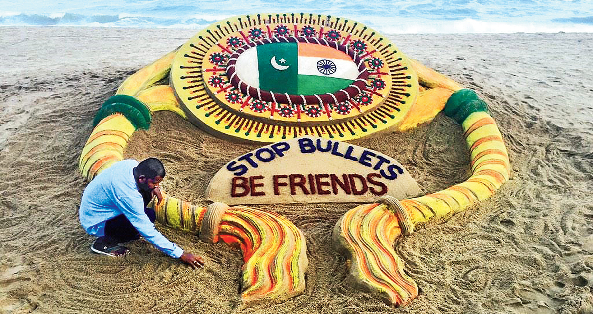 A sand-artist sends out a message for peace