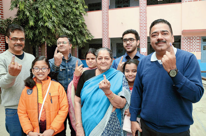 High court Justice Rajesh Shanker (right) and his family members show their inked fingers outside a polling booth in Ranchi on Thursday. 