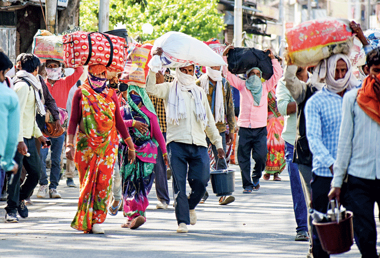 Migrants walk towards their native places amid the lockdown in Allahabad on Saturday.