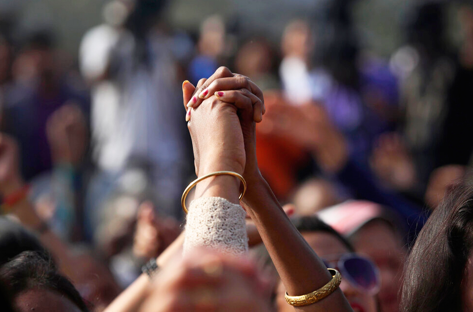 Protesters hold hands and shout slogans during a protest against the Citizenship Act in Guwahati, Thursday, December 19, 2019.