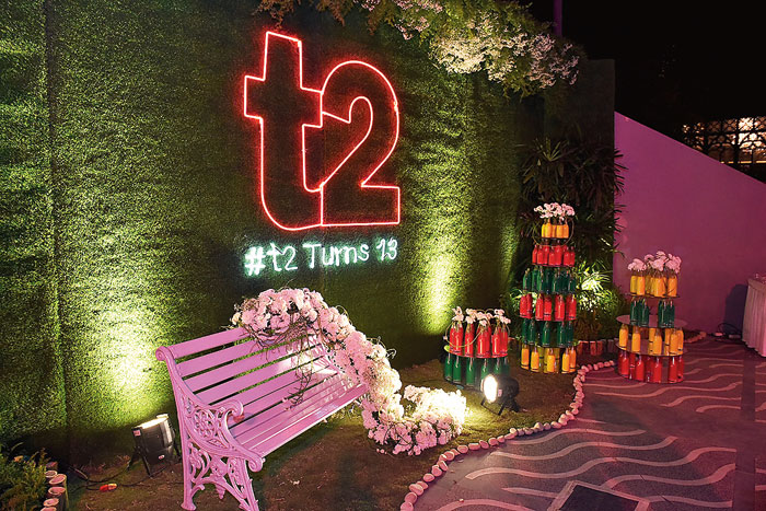 One of the prettiest and most photographed spots of the night was this green wall with a neon t2 logo that greeted you right as you entered the party area. It was done by Baisakhi Ghosh, conceptualiser and managing director of BFPL. “This was like an organic and breathable space with greenery and flowers. We had a backdrop with greens with a 4ft t2 written in neon pink with the party hashtag. This space was also done up with around 70 bottles filled with edible psychedelic colours and chrysanthemums on a pretty white bench,” said Baisakhi.