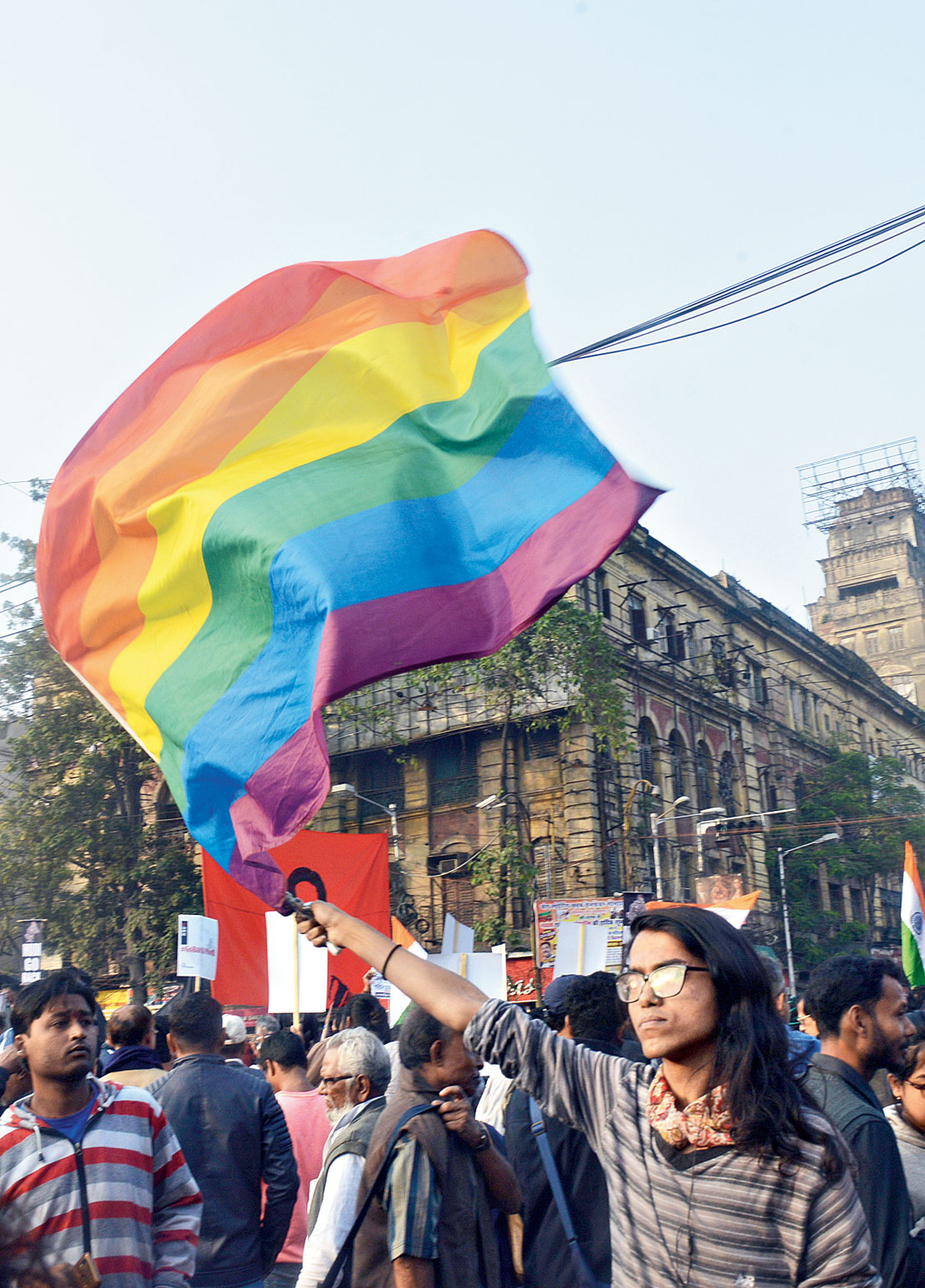 3.56pm: A protester holds a rainbow flag at Esplanade on Saturday afternoon