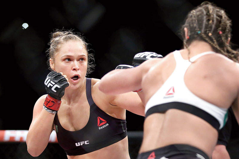 Ronda Rousey: Bold, brutal, belligerent, and unapologetically badass, Ronda Rousey has left an indelible impression wherever she has gone. First hogging the limelight in the wake of her historic Olympic bronze medal in judo for the USA in 2008, Rousey went to become one of the most recognisable fighters in the world during her stint with the Ultimate Fighting Championship (UFC), whose hall of fame she joined as its first female inductee in 2018. Voted as the best female athlete of all time in a 2015 ESPN fan poll, Rousey has also enjoyed success in showbiz and is currently under contract with sports entertainment’s signature company, World Wrestling Entertainment (WWE). From conquering one and all as an unstoppable force in the UFC to battling depression and losing her undefeated streak, Rousey’s efforts and choices have been alternately venerated and vilified; but in the litmus test of power and passion, she has invariably emerged vindicated.