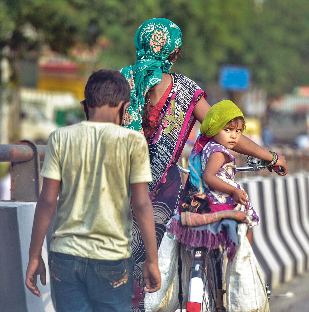 Migrant worker Kiran Devi walks along a Delhi road with her children on Wednesday on her way home to Chhatarpur in Madhya Pradesh. She started her journey from Jalandhar in Punjab on May 23.