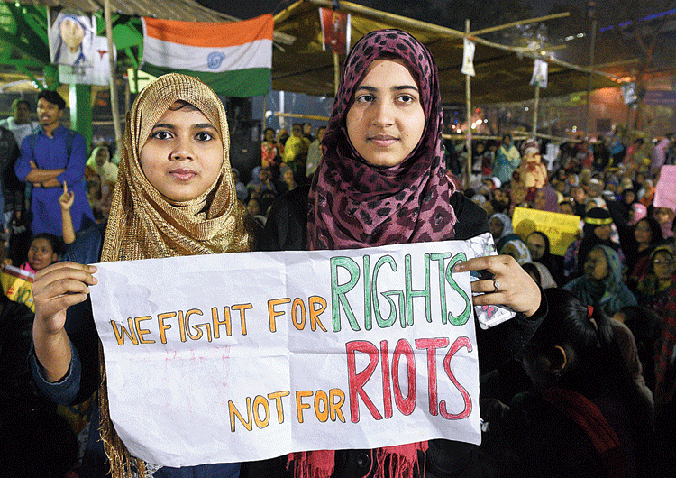Protesters at Park Circus Maidan hold a  poster on Wednesday evening that reads:  We fight for rights; not for riots. 

